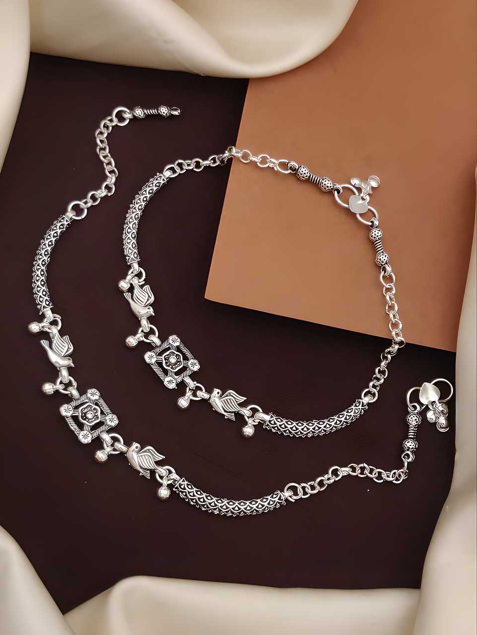Elegantly crafted silver plated anklets designed to enhance your feminine charm. These versatile accessories feature durable plating for lasting shine and comfortable wear. Perfect for casual outings, beach days, or traditional celebrations, they add a sophisticated touch to any ensemble while complementing various foot shapes and sizes.