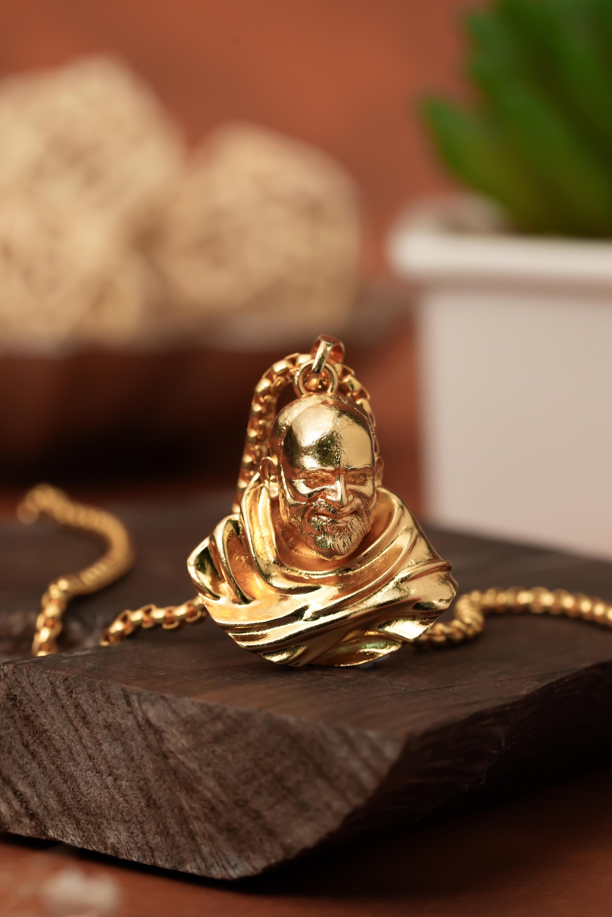 This Sterling Gold Plated Neem Karoli Baba Pendant combines spiritual significance with elegant craftsmanship. Meticulously designed for devotees, the pendant features a detailed representation of the revered saint on premium sterling silver with gold plating. The pendant's durable construction ensures longevity while maintaining its lustrous finish, making it an ideal spiritual accessory for daily wear or special occasions.