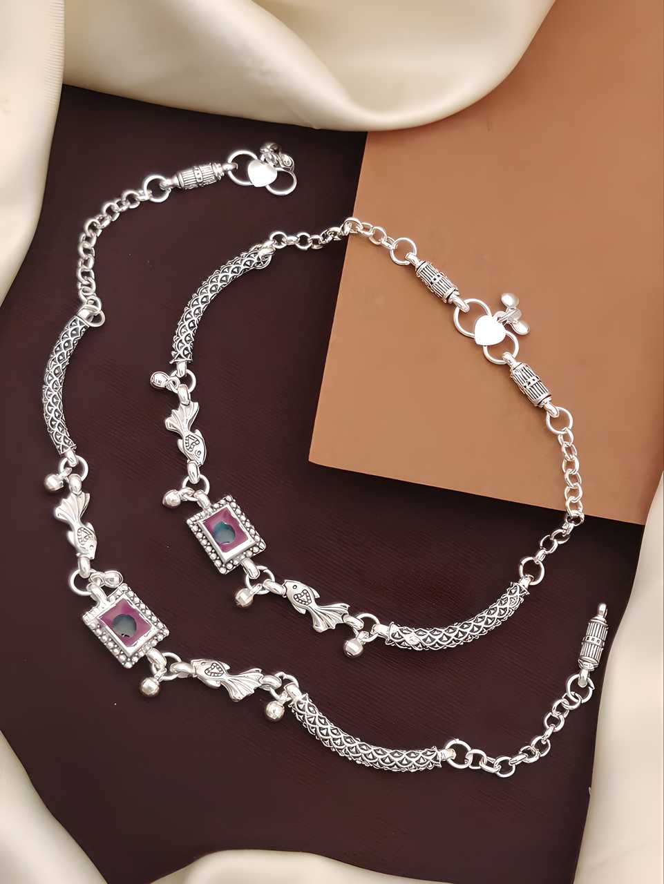 Elegantly crafted silver plated anklets designed for the modern woman. These anklets feature durable plating that maintains its luster through regular wear. The adjustable design ensures a comfortable fit for all ankle sizes, making them suitable for both casual everyday styling and special occasions. Perfect for adding a subtle touch of sophistication to any outfit.