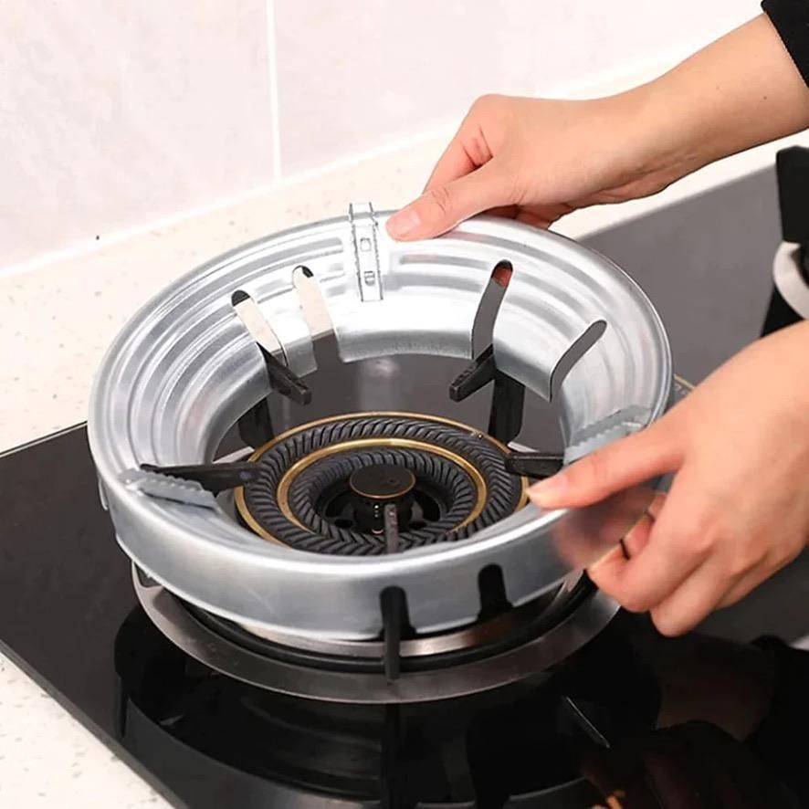 This Gas Stove Fire & Windproof Saving Stand features precision-engineered barriers that shield cooking flames from wind disruption while maximizing thermal efficiency. The strategic design redirects and concentrates heat upward, reducing gas consumption by up to 30% during cooking operations. Fabricated from high-grade heat-resistant materials, it maintains structural integrity through repeated heating cycles while providing stable support for various cookware sizes.