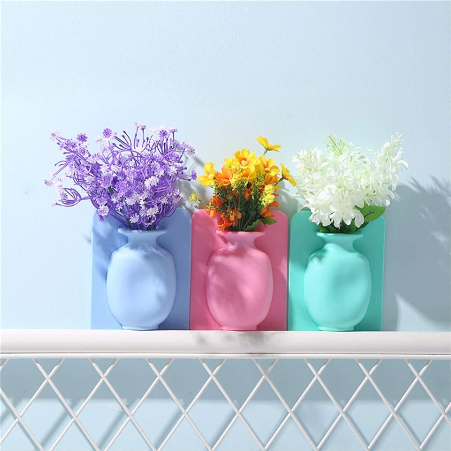 This wall-mounted silicone vase offers a versatile and modern solution for displaying flowers or small plants. Crafted from flexible, durable silicone, it adheres securely to smooth surfaces without the need for drilling or hardware. Its removable design allows easy repositioning and cleaning, making it ideal for enhancing any room with minimal effort. Perfect for adding a touch of greenery in compact spaces, this sticky vase combines functionality with sleek aesthetics for expert-level home decor.