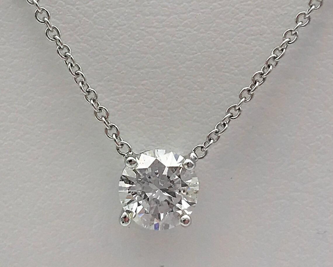 This elegant silver necklace features a specialized weight loss stone believed to support metabolism and energy balance. Crafted with precision, the pendant rests at an optimal position to maximize contact with energy centers. The durable silver chain ensures longevity while complementing any outfit, making it both a functional wellness accessory and a sophisticated jewelry piece.