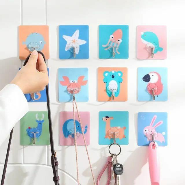 These Hooks-Cartoons Strong Adhesive Wall Sticky Hooks come in a pack of four, designed for reliable and damage-free mounting. Their strong adhesive backing ensures secure attachment to various surfaces, making them ideal for organizing and decorating your space efficiently. Easy to install and remove, these hooks provide a practical solution for hanging lightweight items without drilling or tools. Perfect for both home and office use, they combine functionality with a playful cartoon design to add a touch 