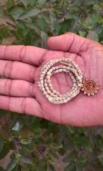 Handcrafted Tulsi Mala featuring a distinctive Radha Name Pendant, combining spiritual significance with elegant design. The sacred Tulsi beads are meticulously strung to provide durability while honoring traditional craftsmanship. This devotional accessory serves as both a meaningful religious symbol and a refined personal adornment for spiritual practitioners.