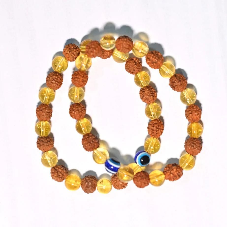 Rudraksha Citrine Crystal Bracelet (Pack of 2)

Harness the ancient power of Rudraksha beads combined with energy-enhancing Citrine crystals in this authentic bracelet set. Each pack contains two meticulously crafted bracelets designed to promote spiritual balance, prosperity, and positive energy flow. The natural variations in these sacred materials ensure each bracelet is uniquely yours, making them perfect for personal use or as meaningful gifts for those on a spiritual journey.