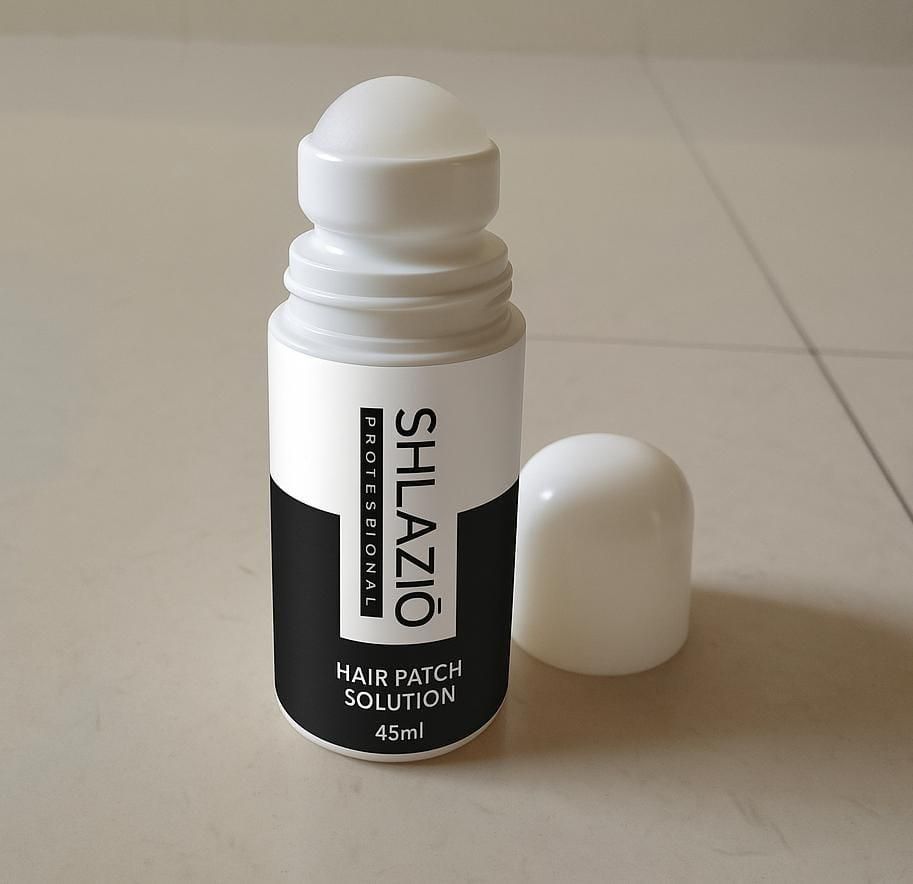 Shlaz Hair Patch Solution provides professional-grade adhesive performance in a precise 45ml application. Specifically engineered for hair systems, this specialized formula creates a secure bond that withstands daily activities while remaining discreet. The balanced composition ensures optimal hold without compromising scalp health, making it the preferred choice among hair replacement specialists.