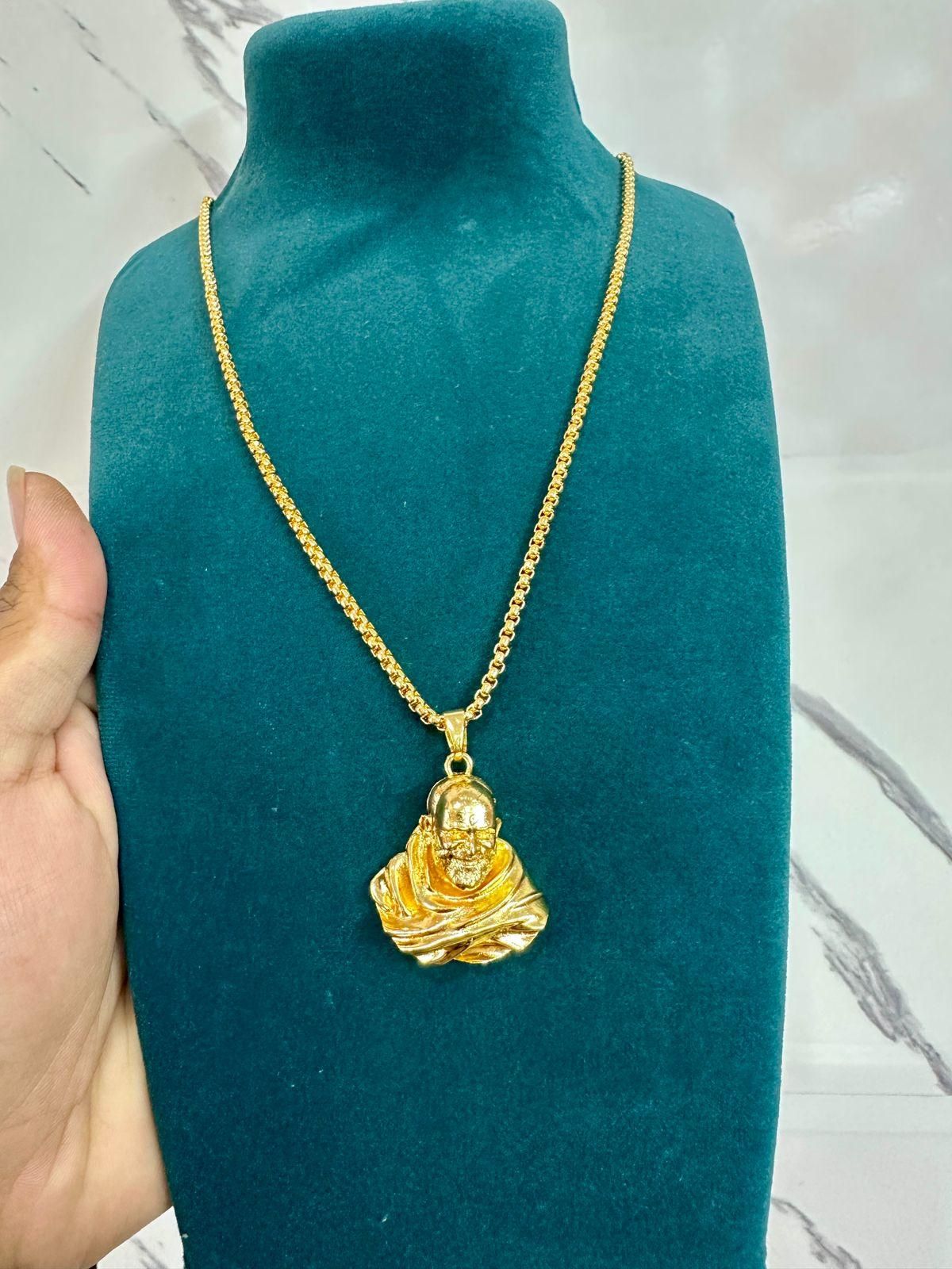 This Sterling Gold Plated Neem Karoli Baba Pendant combines spiritual significance with elegant craftsmanship. Meticulously designed for devotees, the pendant features a detailed representation of the revered saint on premium sterling silver with gold plating. The pendant's durable construction ensures longevity while maintaining its lustrous finish, making it an ideal spiritual accessory for daily wear or special occasions.