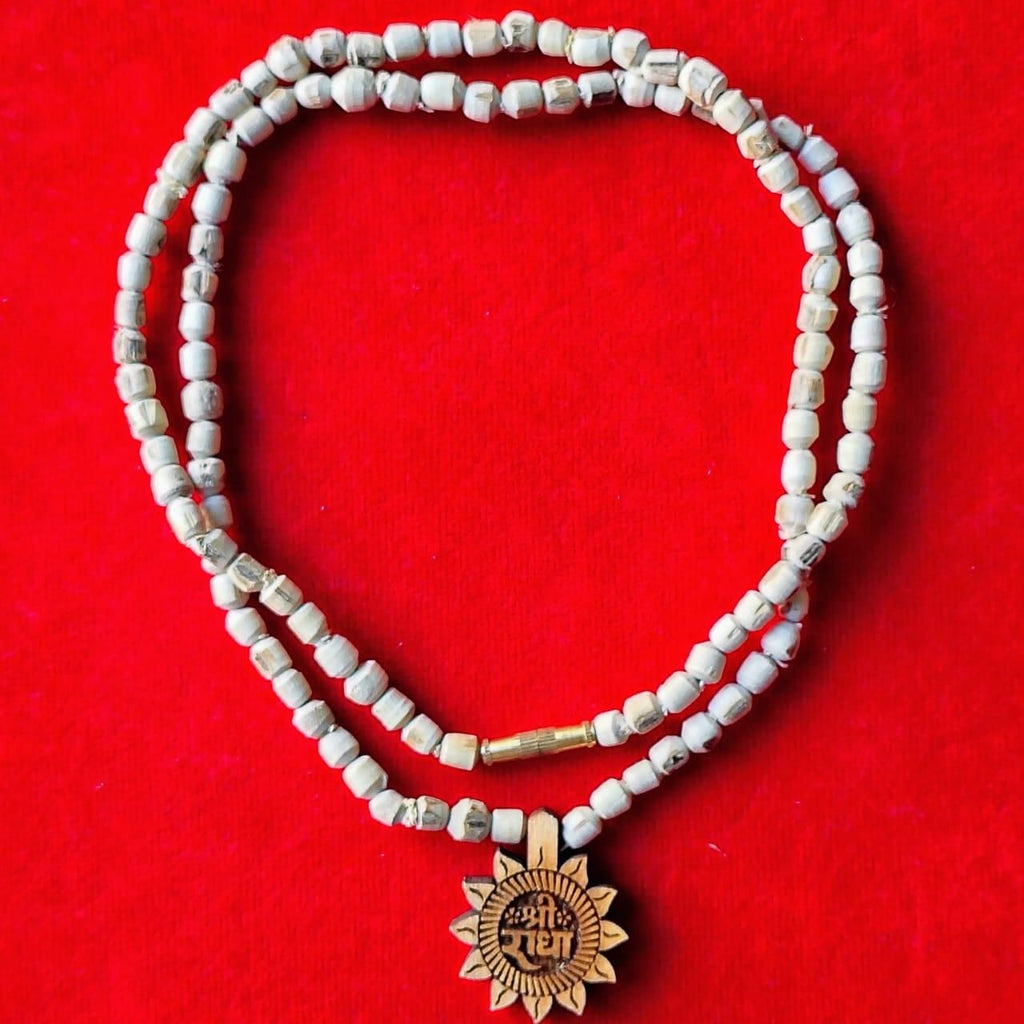 Handcrafted Tulsi Mala featuring a distinctive Radha Name Pendant, combining spiritual significance with elegant design. The sacred Tulsi beads are meticulously strung to provide durability while honoring traditional craftsmanship. This devotional accessory serves as both a meaningful religious symbol and a refined personal adornment for spiritual practitioners.