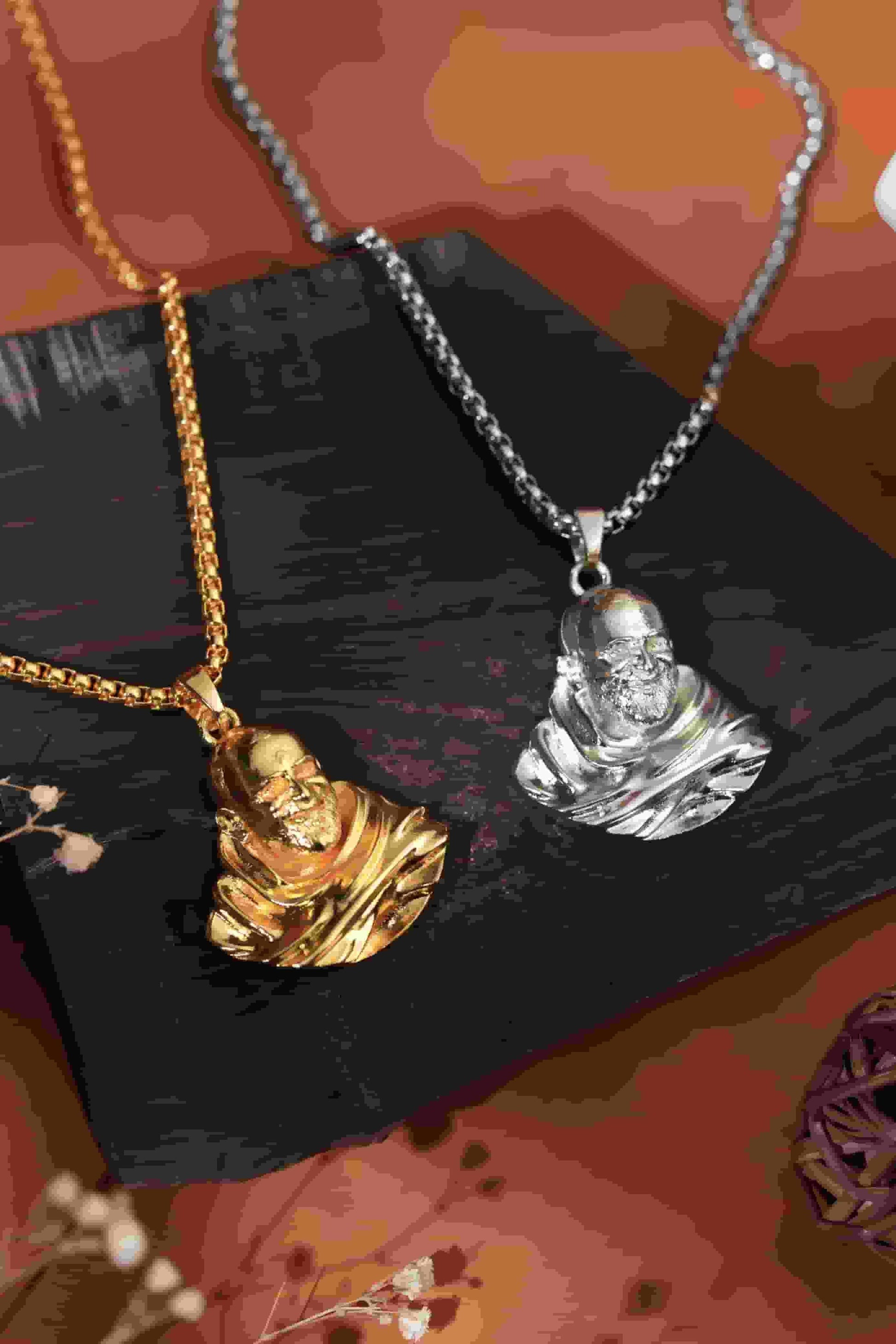 This Sterling Gold Plated Neem Karoli Baba Pendant combines spiritual significance with elegant craftsmanship. Meticulously designed for devotees, the pendant features a detailed representation of the revered saint on premium sterling silver with gold plating. The pendant's durable construction ensures longevity while maintaining its lustrous finish, making it an ideal spiritual accessory for daily wear or special occasions.