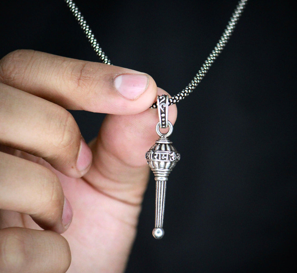 This men's silver chain is adorned with a Gada pendant, adding a touch of uniqueness to any outfit. Made with high-quality silver, this chain is durable and stylish. Perfect for those who want to make a statement, while still maintaining a sophisticated look.