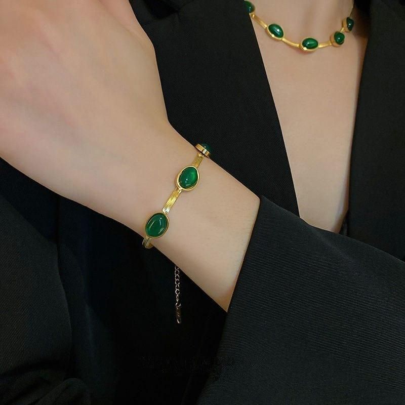 Expertly crafted, this Oval Green Crystal Pendant Necklace Set with Bracelet is a must-have accessory. Featuring a stunning green crystal pendant and matching bracelet, this set adds a touch of elegance to any outfit. Handmade with precision, this set is sure to make a statement.