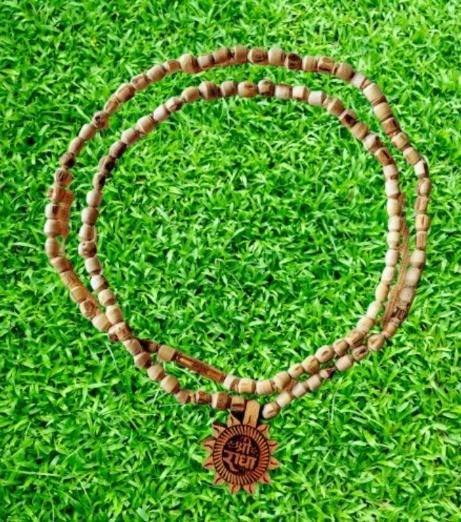 Handcrafted Tulsi Mala featuring a distinctive Radha Name Pendant, combining spiritual significance with elegant design. The sacred Tulsi beads are meticulously strung to provide durability while honoring traditional craftsmanship. This devotional accessory serves as both a meaningful religious symbol and a refined personal adornment for spiritual practitioners.