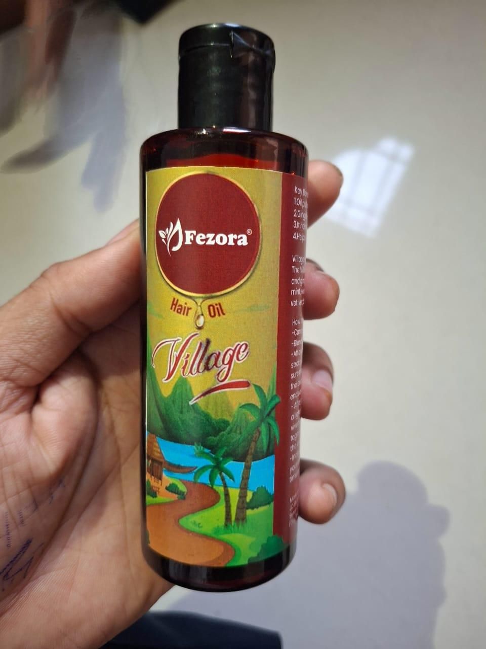 Fezora Village Hair Oil combines time-tested botanical extracts in a potent formula designed to address multiple hair concerns. This value pack of two 100ml bottles provides comprehensive hair care, targeting issues from the root to tip. The specialized blend penetrates deeply to strengthen follicles, restore moisture balance, and protect against environmental damage, resulting in visibly healthier, more manageable hair with continued use.
