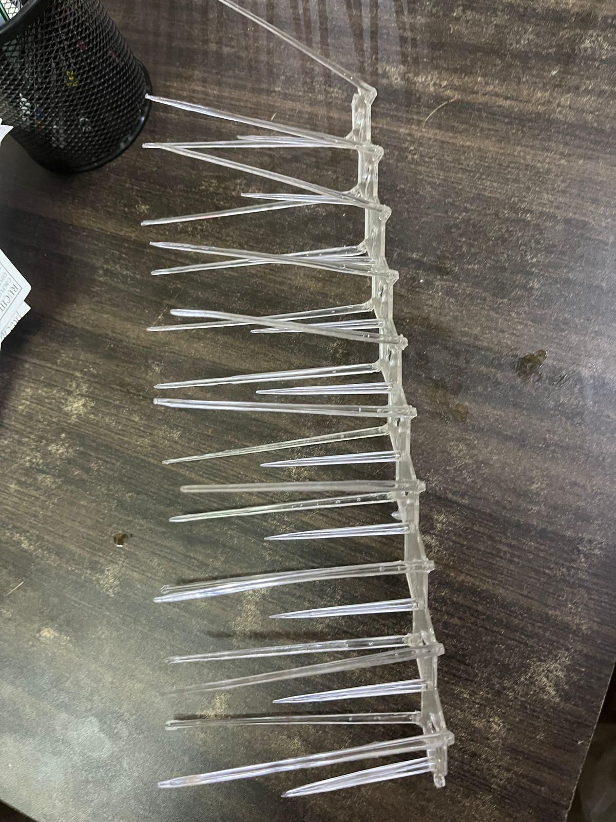 Professional-grade bird deterrent system featuring 10 interlocking polycarbonate spike strips. Designed with precise spacing to prevent nesting and perching without causing harm to birds. UV-resistant construction ensures longevity in all weather conditions. Ideal for ledges, signs, and architectural features where bird activity causes damage and unsanitary conditions. Includes mounting hardware for versatile installation options.