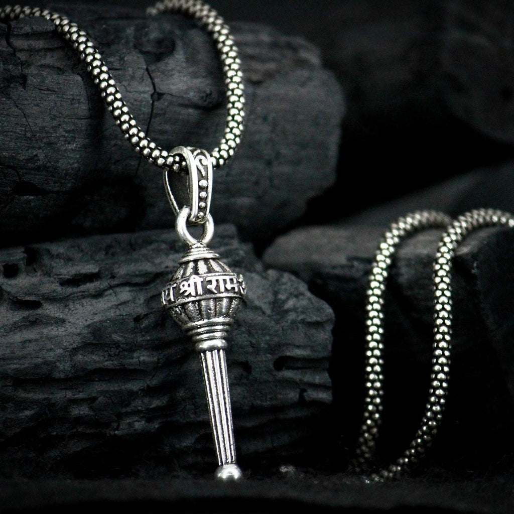 This men's silver chain is adorned with a Gada pendant, adding a touch of uniqueness to any outfit. Made with high-quality silver, this chain is durable and stylish. Perfect for those who want to make a statement, while still maintaining a sophisticated look.