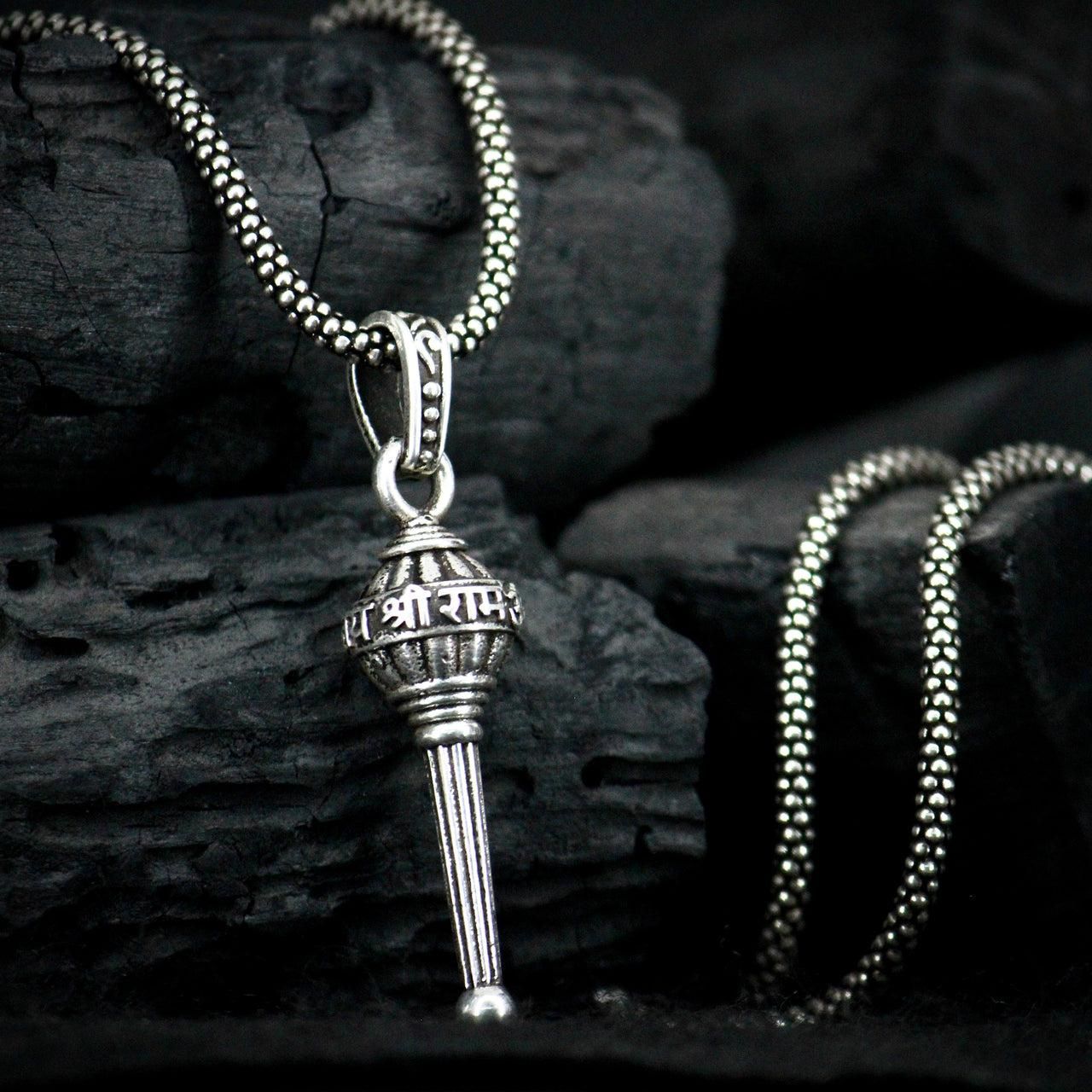 This men's silver chain is adorned with a Gada pendant, adding a touch of uniqueness to any outfit. Made with high-quality silver, this chain is durable and stylish. Perfect for those who want to make a statement, while still maintaining a sophisticated look.