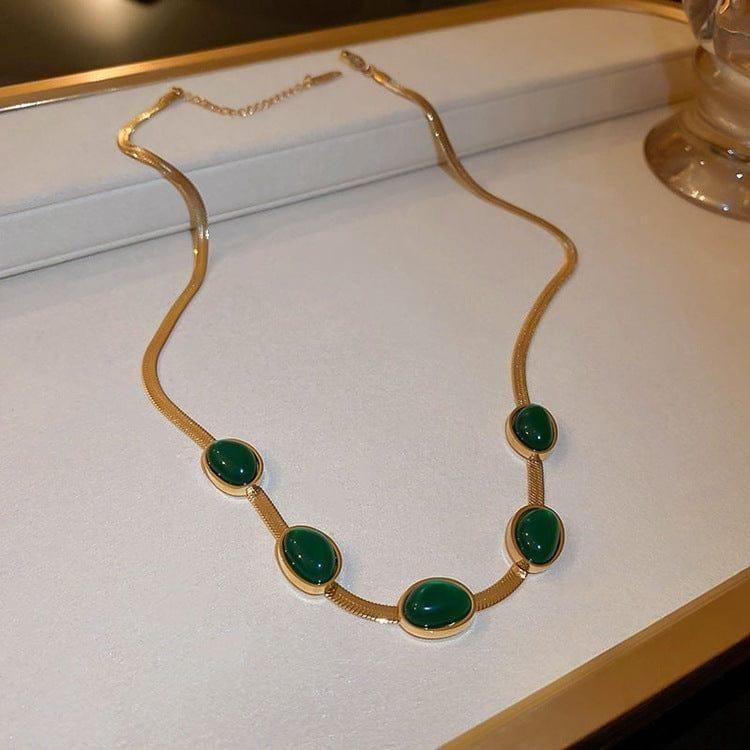Expertly crafted, this Oval Green Crystal Pendant Necklace Set with Bracelet is a must-have accessory. Featuring a stunning green crystal pendant and matching bracelet, this set adds a touch of elegance to any outfit. Handmade with precision, this set is sure to make a statement.