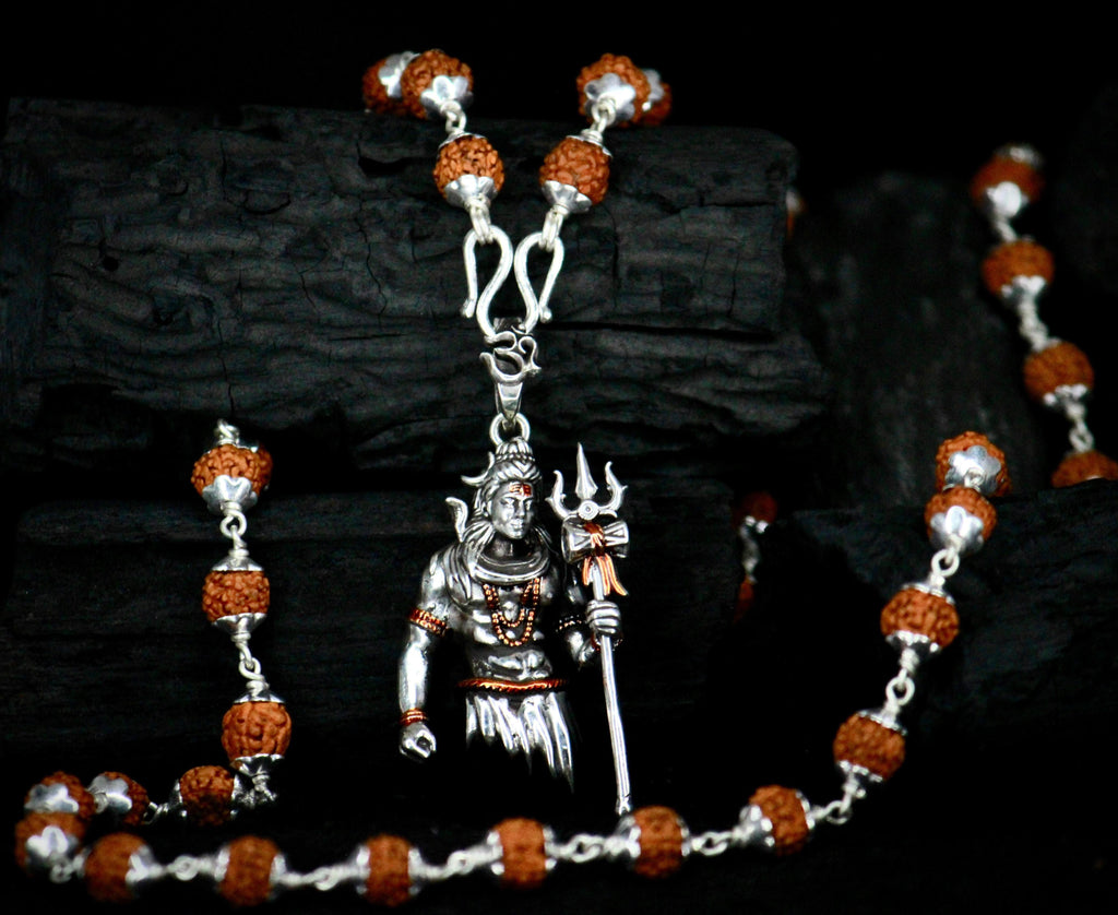 Rudraksha Shivji Pendant With Chain

Authentic Rudraksha Shivji Pendant with Chain combines spiritual significance with elegant design. The sacred Rudraksha bead, known for its protective properties, is paired with a meticulously crafted Shivji motif. This pendant serves as both a meaningful religious symbol and a distinguished accessory, offering wearers a connection to ancient Vedic traditions while enhancing their attire with timeless sophistication.